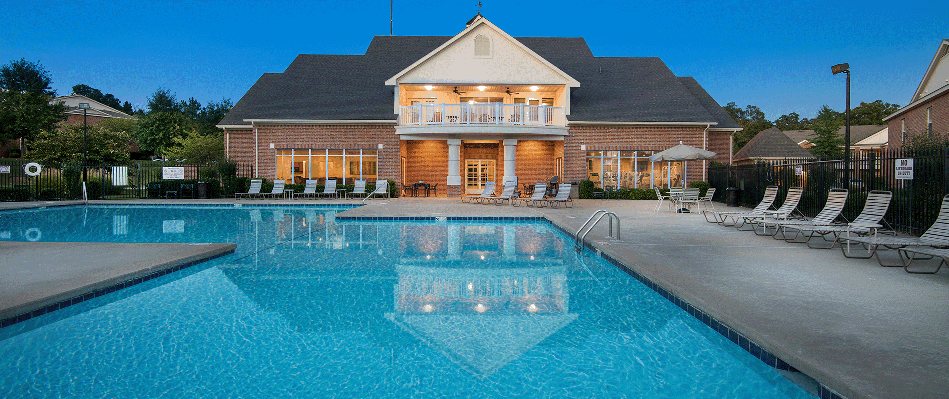 a swimming pool in front of a house